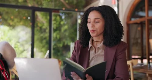 Happy woman, laptop and video call with book in cafe for online meeting, discussion or chat