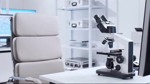 Modern Microscope in Clean, Empty Laboratory Setting