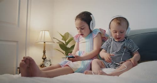 Girl and Baby Listening to Music at Home