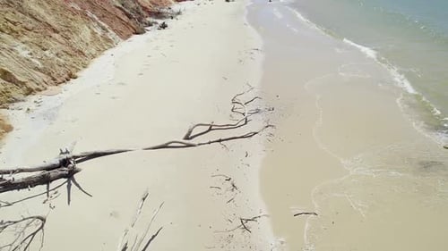 Female Tourist Looking Up At Drone Camera While Walking At Rainbow Beach In Cooloola, Queensland. ae