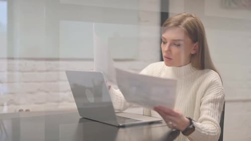 Business Woman Reviews Documents Positively