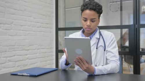 Medical Professional Using Tablet in Hospital Office
