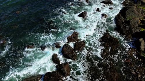 Waves Hitting Wave Beaten Rocks Along Coastal Edge Sea Striking Surf Washed Stones on Seaside Border