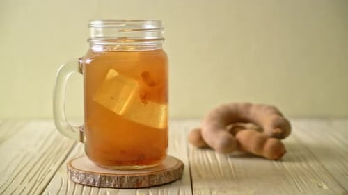 Delicious sweet drink tamarind juice and ice cube - healthy drink style