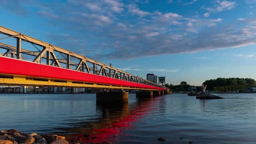 Red Bridge spanning River at Sunset Time-Lapse
