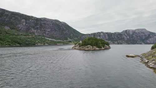 Drone Flight Over Water With Rugged Rocky Mountains In View