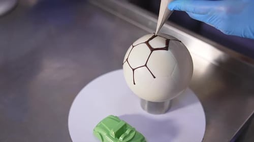 Decorating White Chocolate Soccer Ball with Dark Chocolate