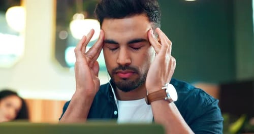 Man, headache and stress on laptop at cafe for online education, e learning