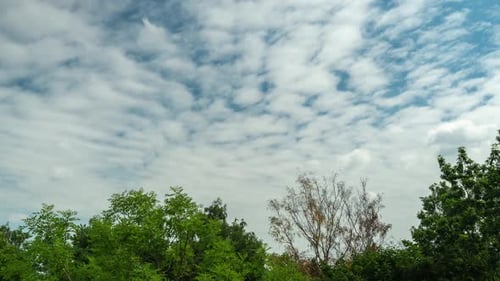 Clouds Float in Bright Blue Sky Time Lapse