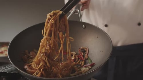 Chef Cooking Noodles in Wok