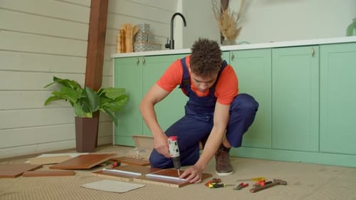 Young Adult Assembling Furniture with Power Drill