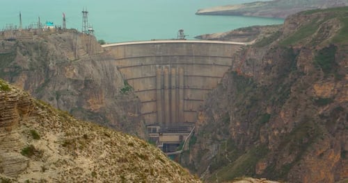 concrete hydroelectric dam embedded in rocky canyon industrial energy structure