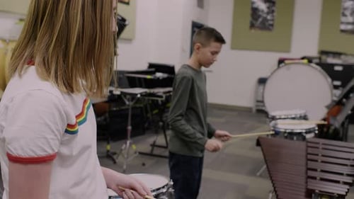 Boy and Girl Playing Instruments in Music Room