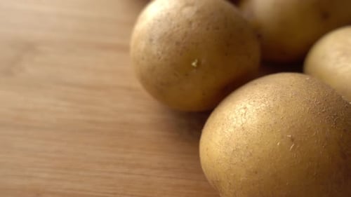 Close-up of fresh raw potatoes on wood