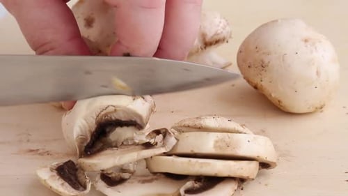 Mushroom Slices on a Wooden Cutting Board