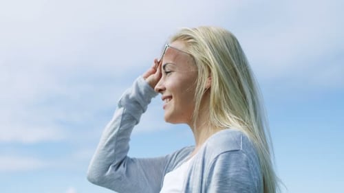 Sweet Young Blonde Runs Hand Through Her Beautiful Blonde Hair and Takes Off Her Aviator Sunglasses