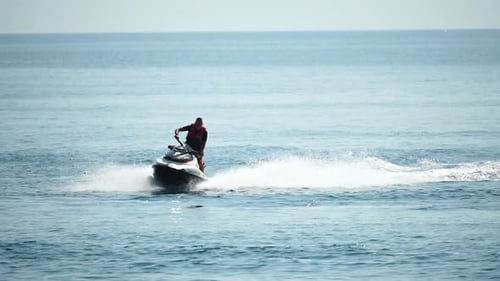 Adult Rides Jet Skiing on Open Water