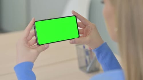 Woman Holding Horizontal Smartphone with Green Screen