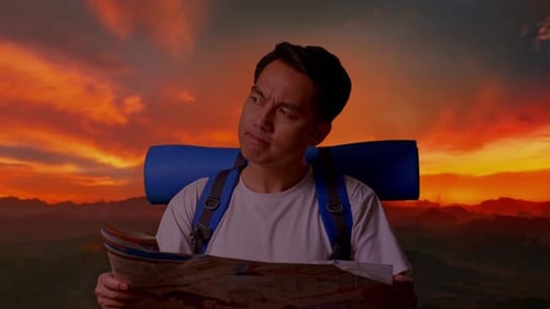 Young Adult Looking at Map During Sunset