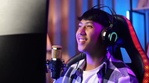 Asian Boy Streamer Lives Stream Playing Game On Computer, Talks On Microphone