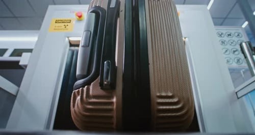 Airport Security Checkpoint Close Up of Passenger Placing Suitcase on Conveyor Belt for Baggage Xray