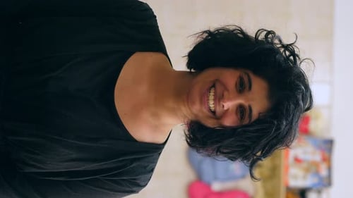 Woman Smiling and Laughing in Black Shirt Indoors