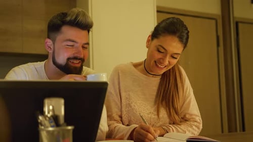 Young Couple Working from Home on Laptop