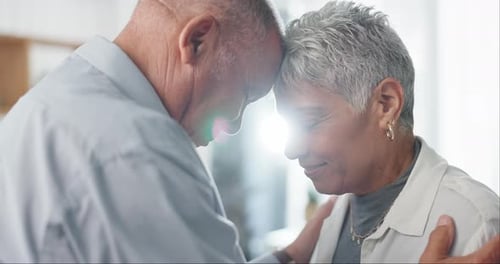 Loving Senior Couple Tenderly Touching Foreheads
