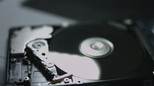 Macro Close Up of Working Opened Hdd Drive Hard Disk Move of Writing Reading Magnetic Head