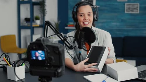Young Woman Vlogging an Unboxing of a Smartphone