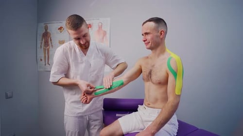Medical Professional Applies Tape to Arm in Office