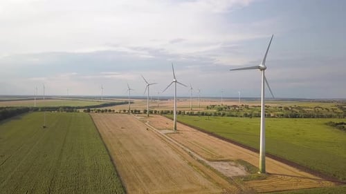 Aerial View of Wind Turbine Generators in Field Producing Clean Ecological Electricity