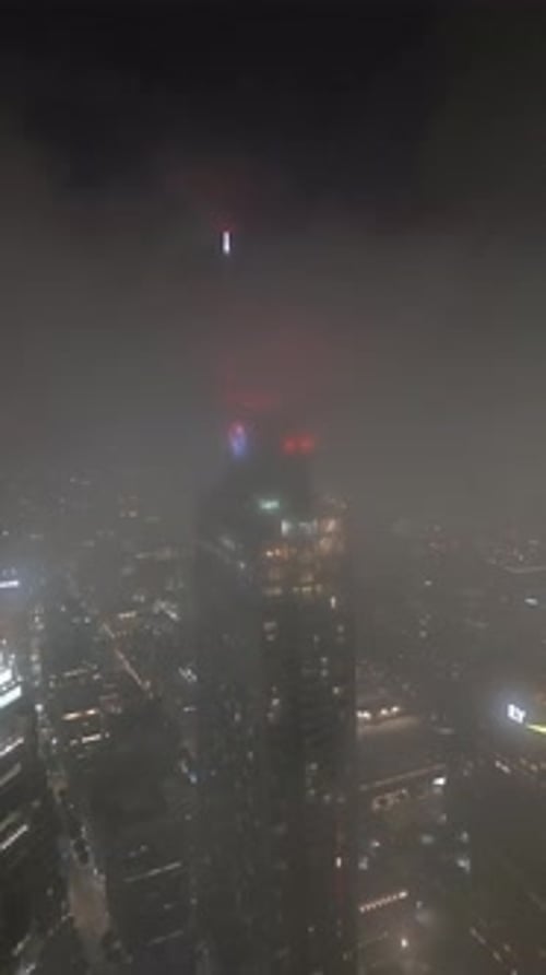 Aerial video of Los Angeles skyline at night in fog, California, USA