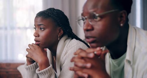 Young Adults Indoors Looking Concerned