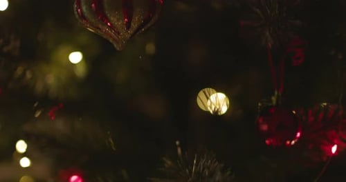 Happy New Year Christmas Tree Decorates on Branch Snow on Background Bokeh of Side Flickering Light
