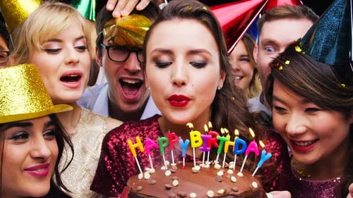 Cake, blowing candles and birthday party with friends in studio on black background