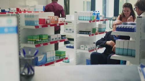 Pharmacist Consults with Patient in Wheelchair