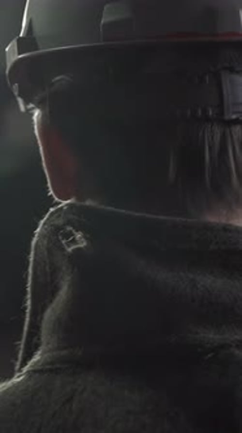 Man in Hard Hat Watching Factory Equipment