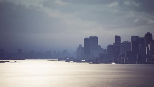 City Skyline at Dusk with Shimmering Water Reflecting the Evening Light