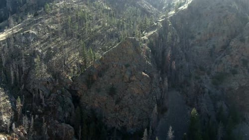 Aerial dolly down of mountains and rock in Colorado