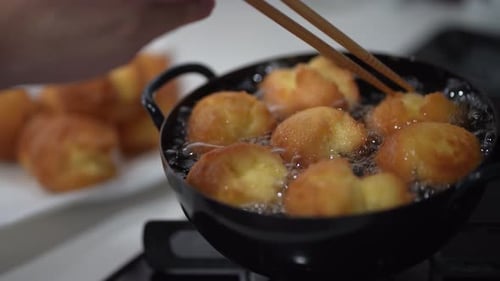 Fritters Frying in Oil Close Up