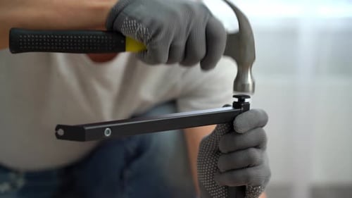 Hands Hammer Furniture Plug or Stub Into Metal Framework of Coffee Table