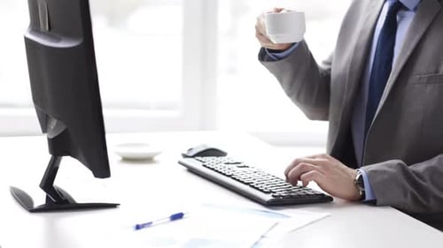 Man Types on Keyboard at Office Desk