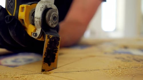 Electrical Saw the Electric Power Carpentry Oscillating Multi Tool Man is Cutting Plywood on the
