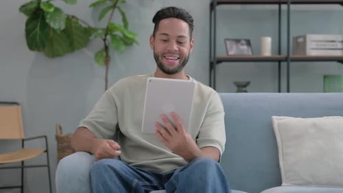 Young Adult Using Tablet Device for Video Call