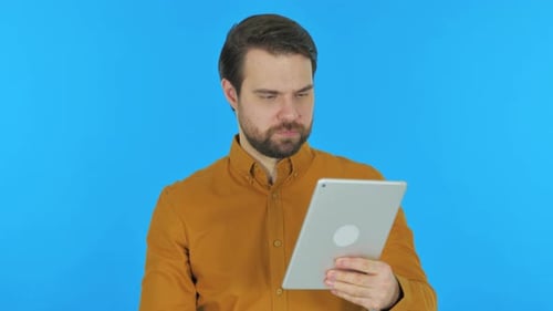 Man Uses Tablet with Negative Reaction