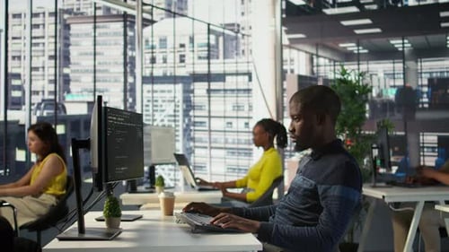 Happy Coworker in Wheelchair Bumping Fists with Programmer