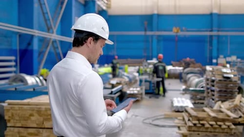 Industrial Worker Engineer Man Tablet at Factory Heavy Machine Metal Sheets Manufacturing Equipment