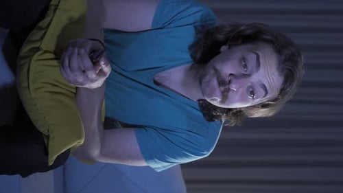 Man Relaxing and Watching TV at Night