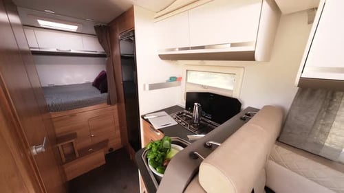 RV Interior with Kitchen and Bed